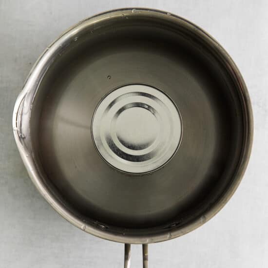 a stainless steel frying pan with a lid.