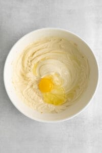 a white bowl with an egg in it.