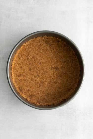 a brown crusted pie in a pan on a white surface.