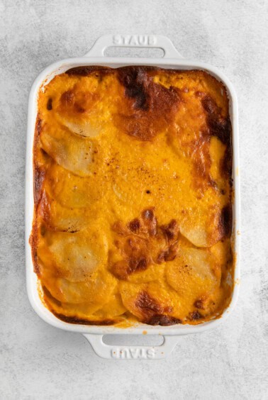 Scalloped potatoes with crispy baked cheese on the top.