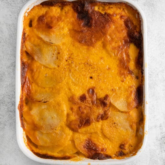 Scalloped potatoes with crispy baked cheese on the top.