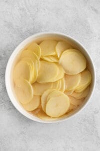 Sliced potatoes in a bowl.