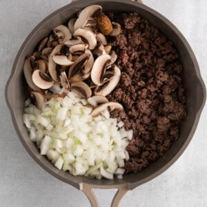 a skillet filled with mushrooms and onions.