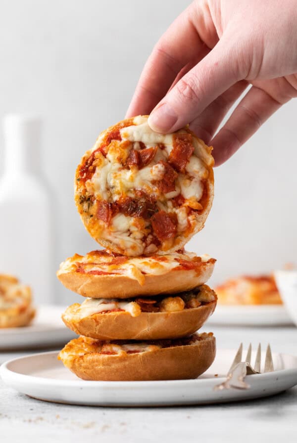 Bagel pizza bites stacked on a plate.