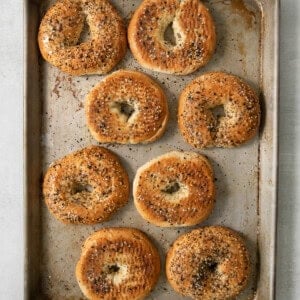 Bagels on a baking sheet.