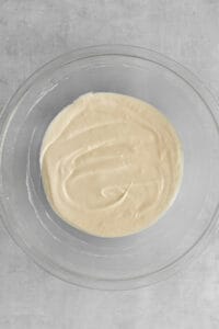 Cream cheese, ricotta, milk, and sugar mixed up in a bowl.