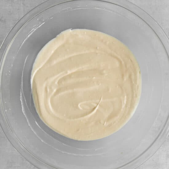 Cream cheese, ricotta, milk, and sugar mixed up in a bowl.