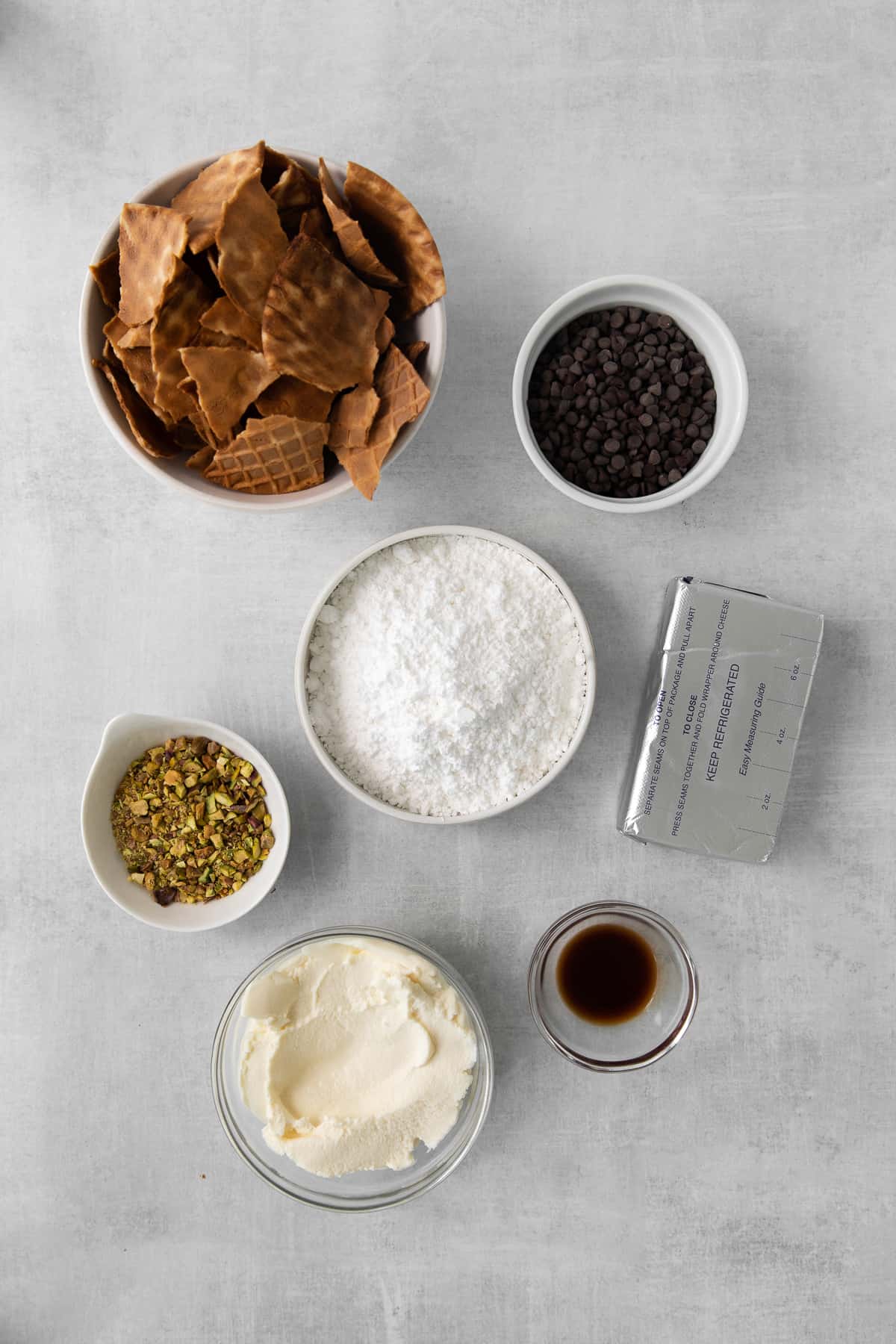 Ingredients for the cannoli dip in small bowls.