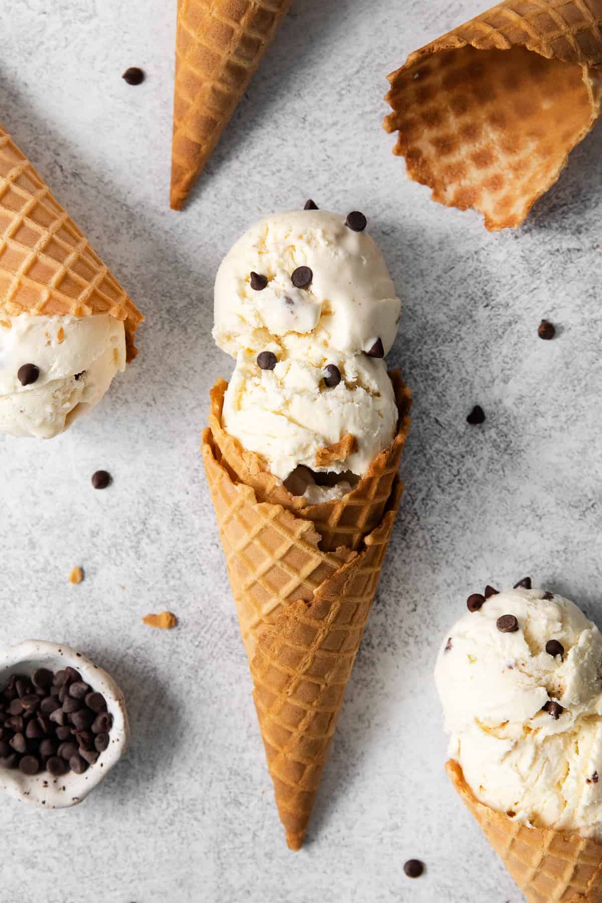 Ice cream cones laying on a counter top.