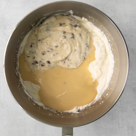 Sweet and condensed milk, cannoli dip, and whipped cream in a bowl.