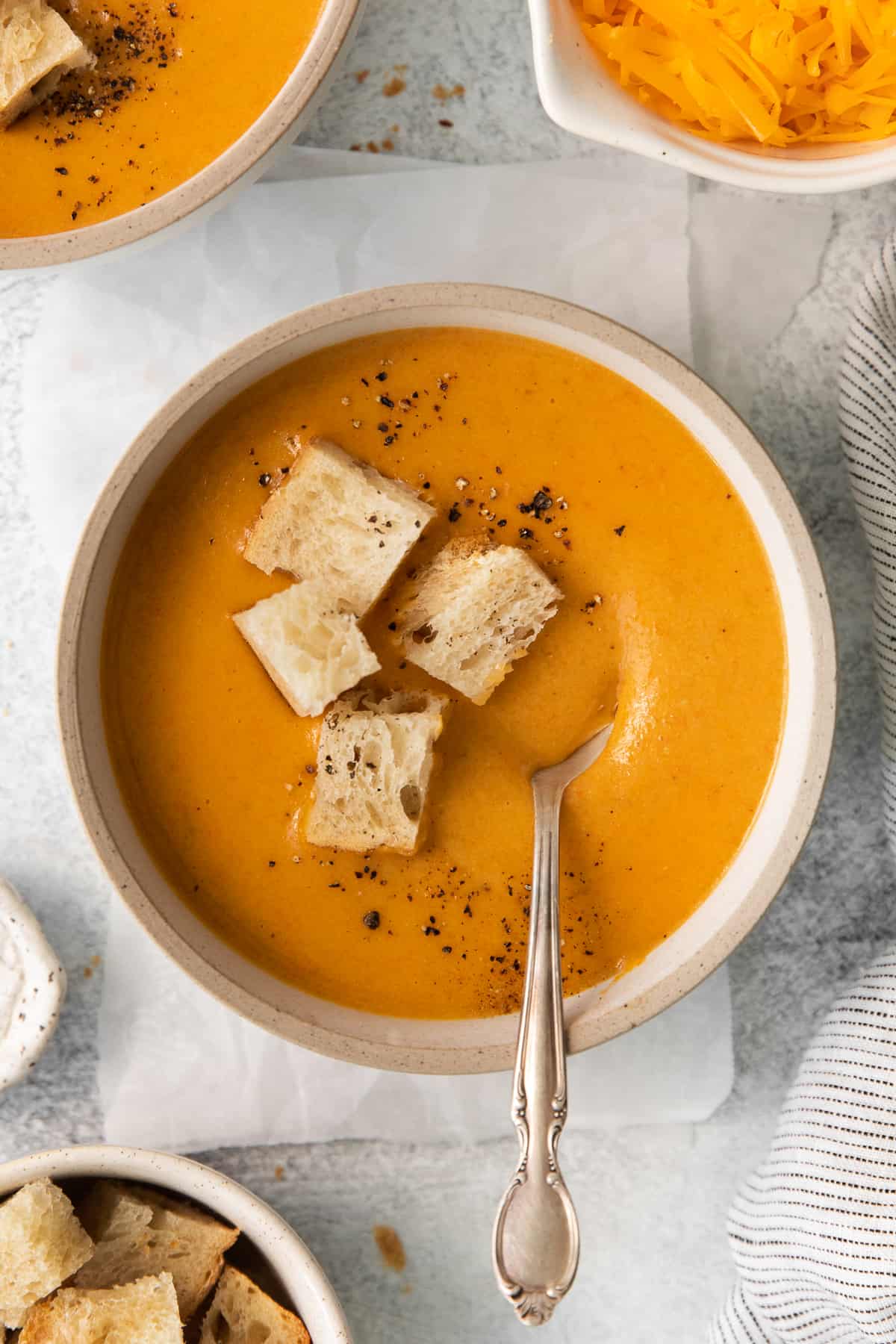 Wisconsin cheese soup in a bowl topped with croutons.