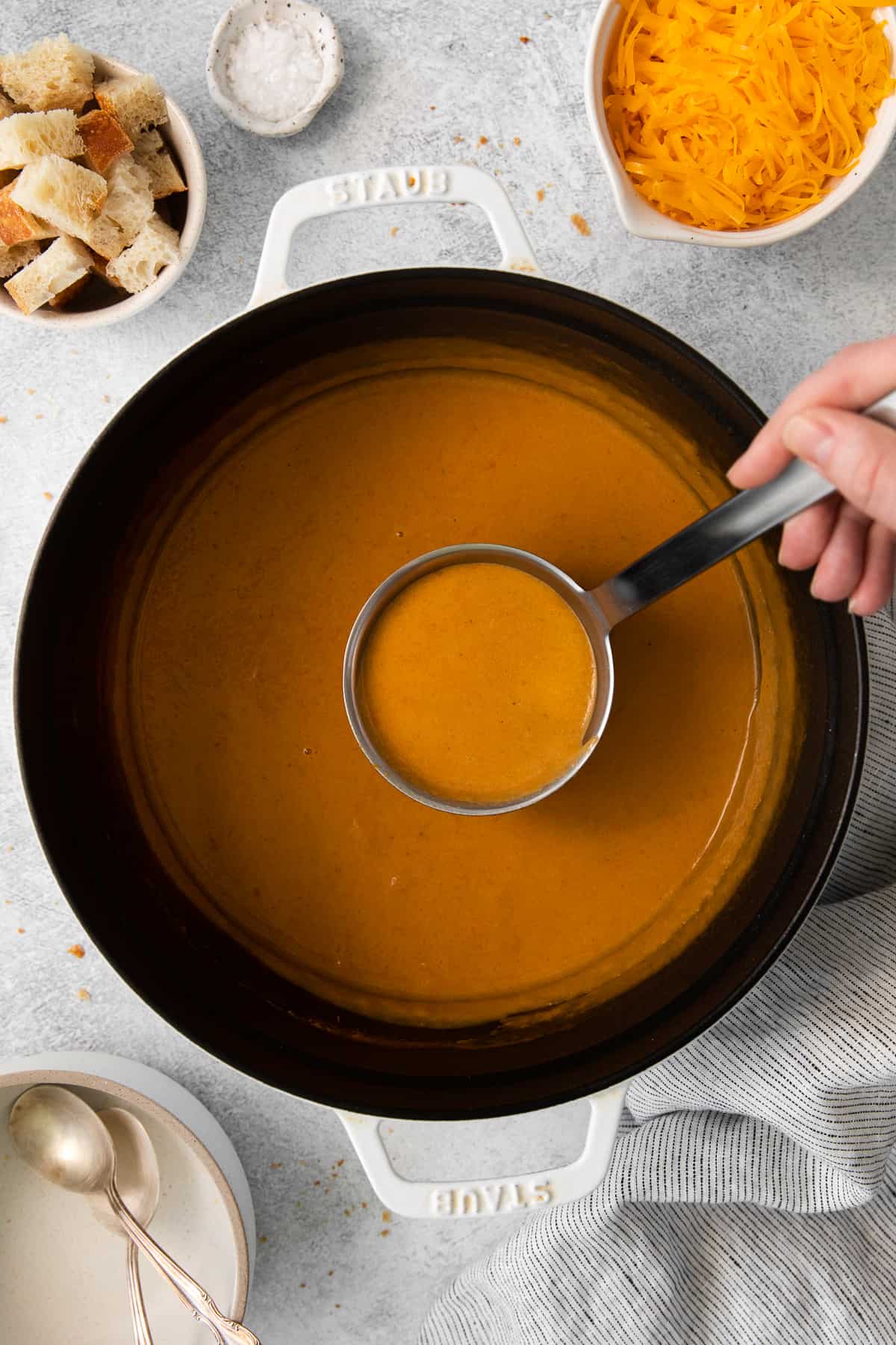 Wisconsin cheese soup on a ladle.