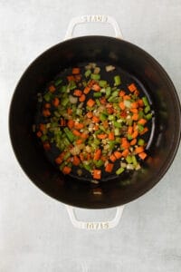 stir-fried vegetables in a pan on a white surface.