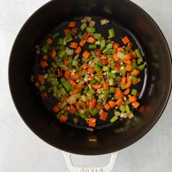 stir-fried vegetables in a pan on a white surface.