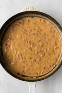 a skillet filled with a brown sauce.