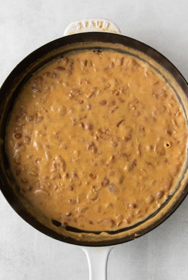 a skillet filled with a brown sauce.