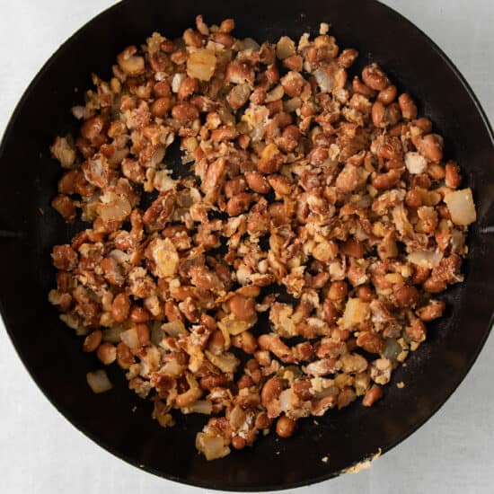 a frying pan filled with nuts and onions.