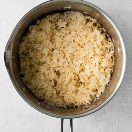 Cheese rice cooked in a sauce pan.