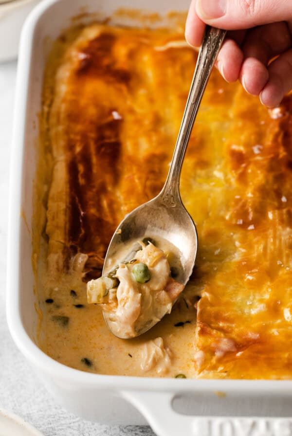 Chicken pot pie casserole on a spoon.