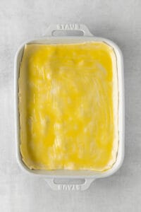 a white baking dish with a yellow filling.