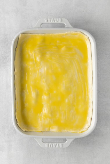 a white baking dish with a yellow filling.