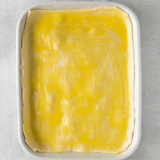 a white baking dish with a yellow filling.