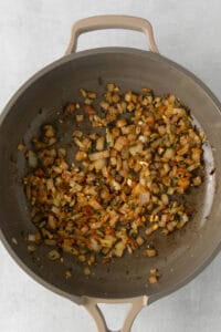 fried onions in a skillet on a white surface.