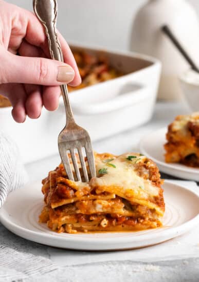 A fork taking a piece of the lasagna.