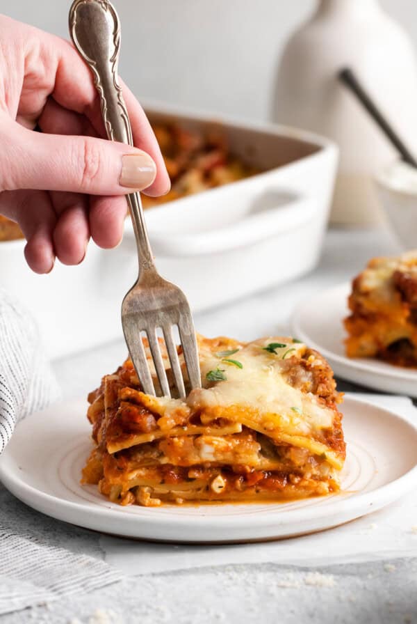 A fork taking a piece of the lasagna.