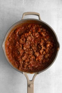 Red sauce for the cottage cheese lasagna in a pan.