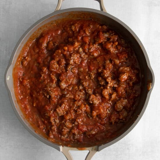 Red sauce for the cottage cheese lasagna in a pan.