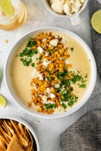 Elote queso in bowl with toppings,