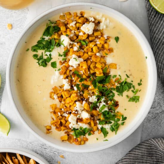 Elote queso in bowl with toppings,