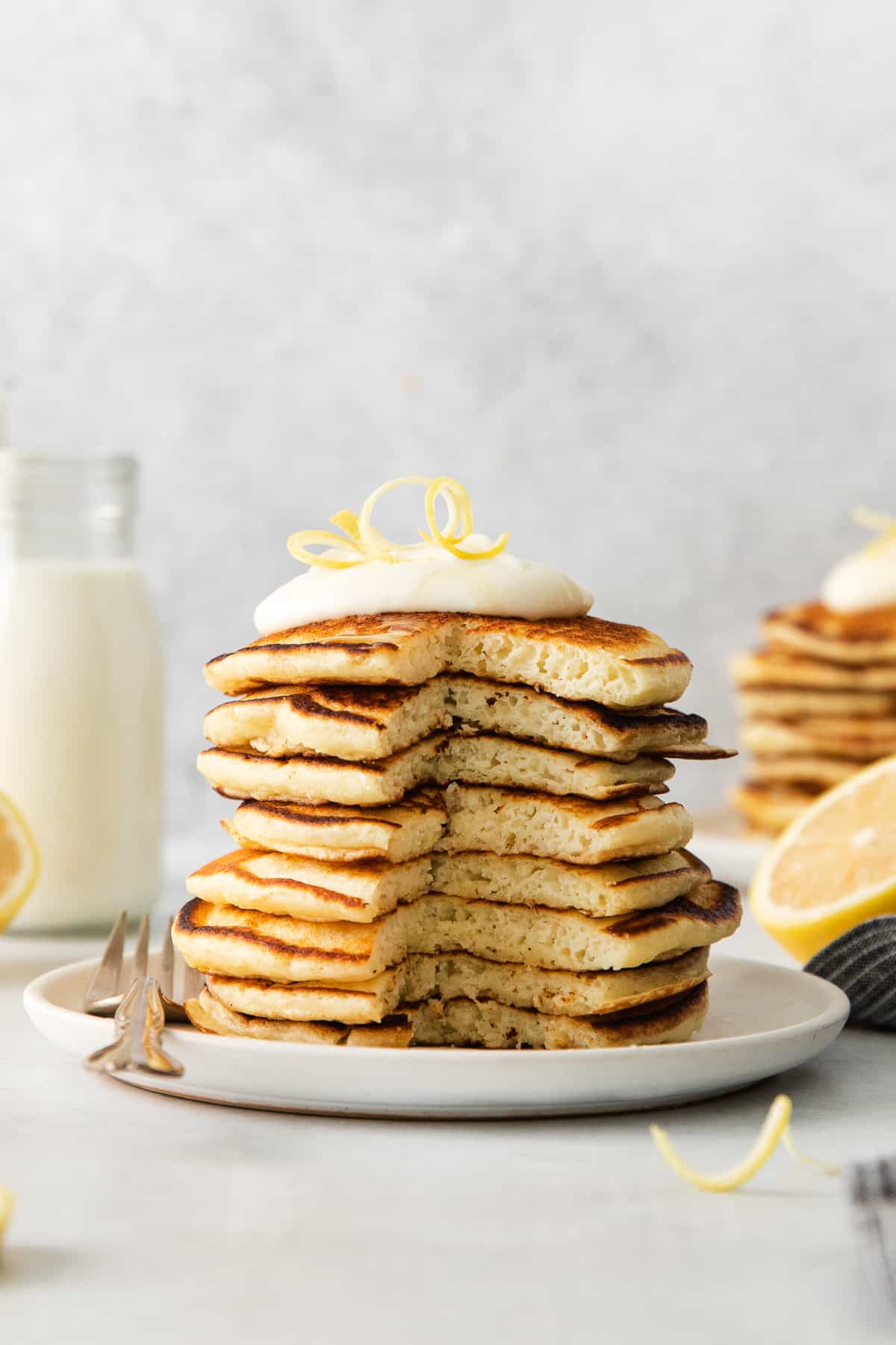 Lemon ricotta pancakes stacked on a plate.