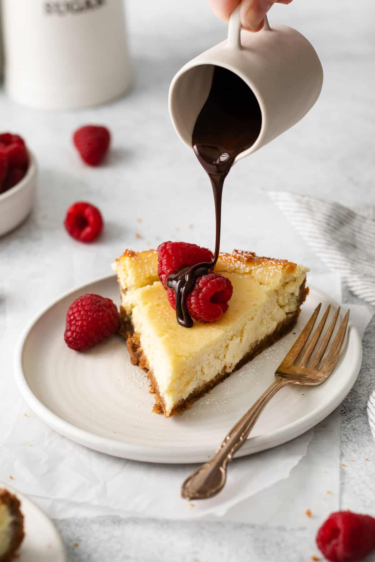 Slice of ricotta cheesecake topped with chocolate.