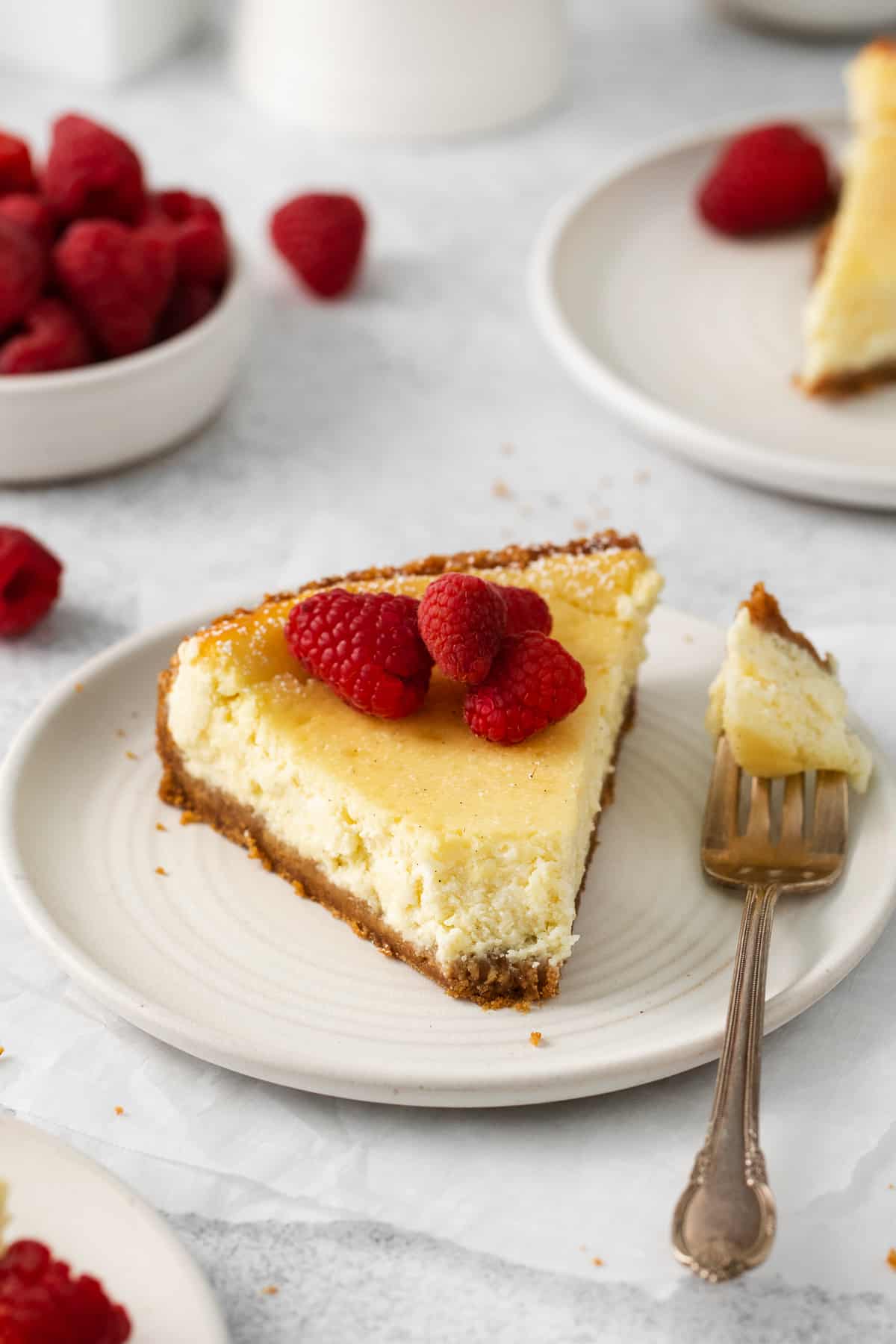 Slice of ricotta cheesecake on a plate.
