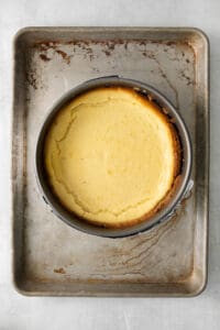 a cheesecake in a metal pan on a table.
