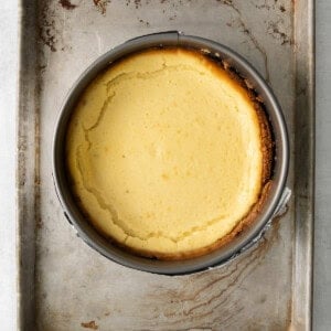 a cheesecake in a metal pan on a table.