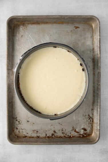 a metal pan with a bowl of cream on it.