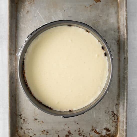 a metal pan with a bowl of cream on it.