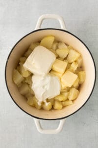 mashed potatoes and butter in a pot.