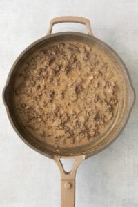 a frying pan with meat in it.