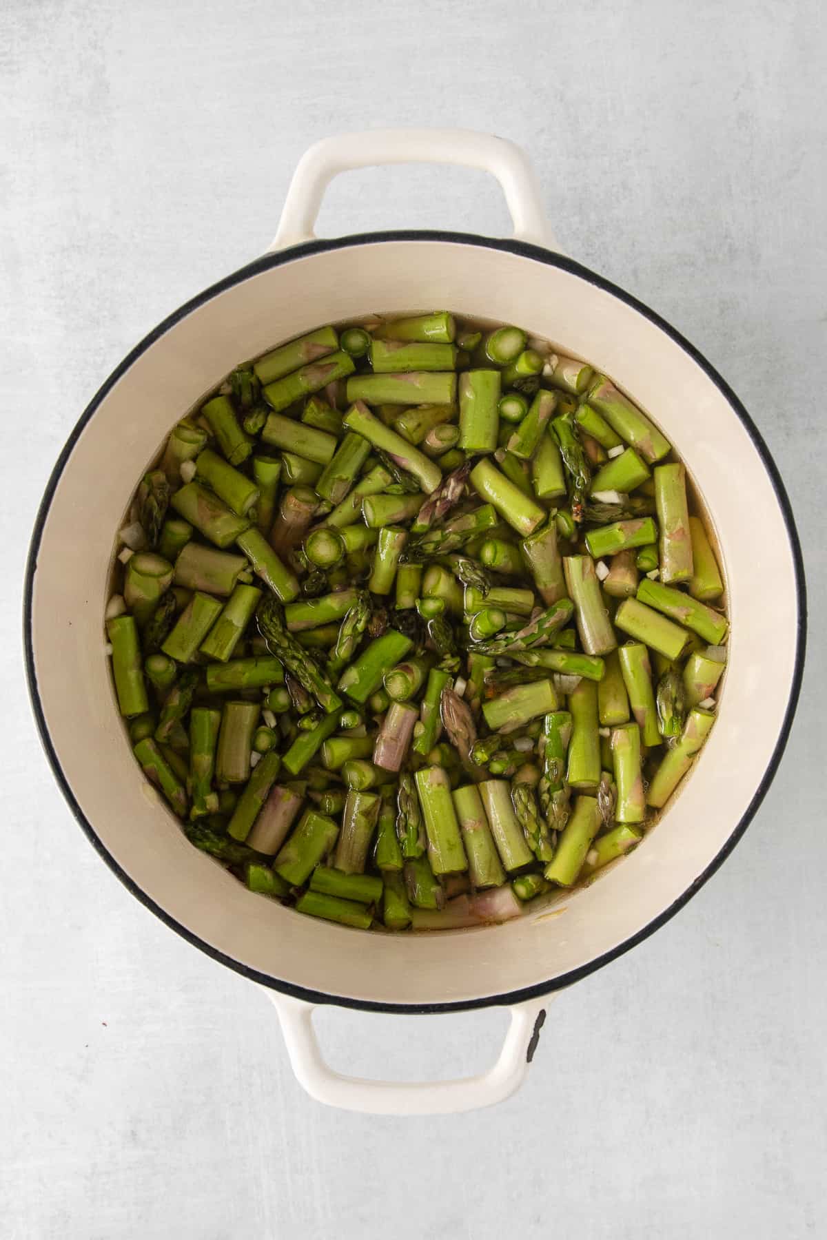 Chopped asparagus in a dutch oven.