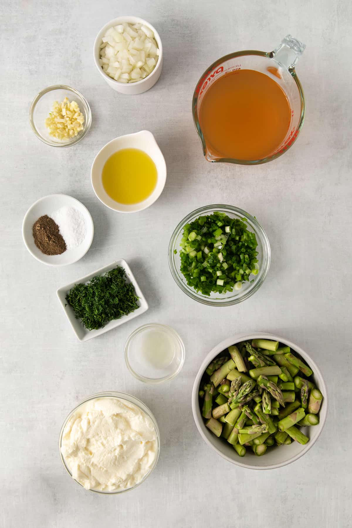 Ingredients for cream of asparagus soup on a counter.