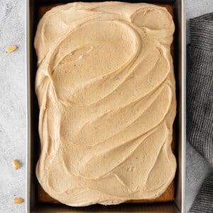 peanut butter banana cake in a pan with frosting and bananas.