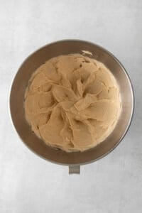 peanut butter cake batter in a metal pan on a white background.