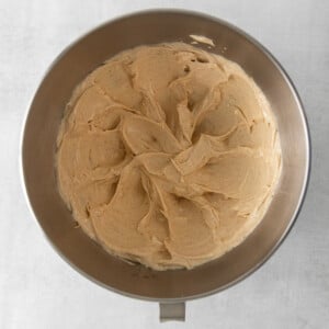 peanut butter cake batter in a metal pan on a white background.