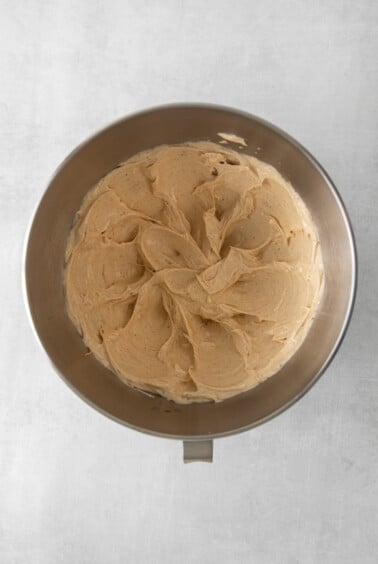peanut butter cake batter in a metal pan on a white background.