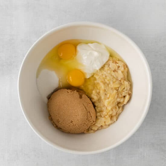 a bowl of oats with an egg and a piece of bread.