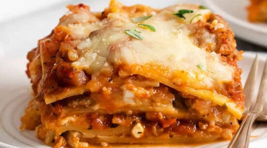 Lasagna on a plate with a fork.